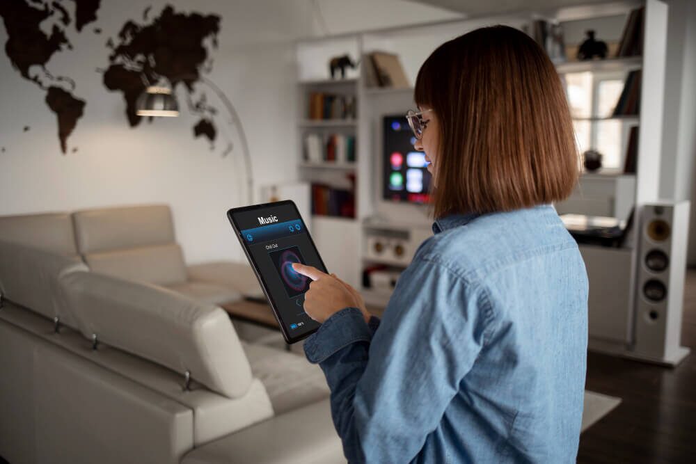 Person using tablet for home automation in modern room